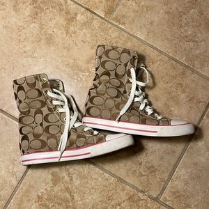 Coach pink high top reversible sneakers.